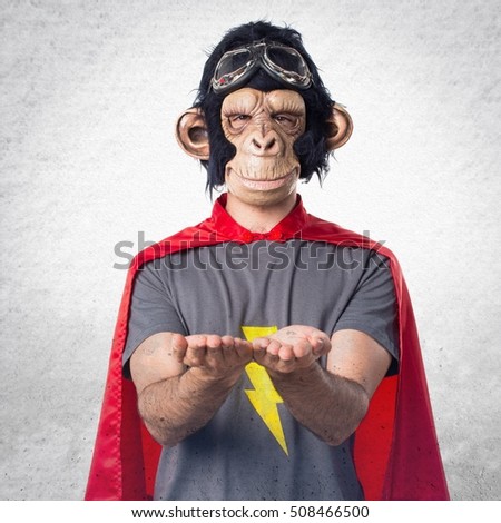 Superhero monkey man holding something on textured background