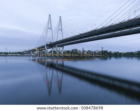 Bolshoy Obukhovsky Bridge (Cable stayed Bridge) at the summer morning light with the shadow of ship, Saint-Petersburg, Russia Royalty-Free Stock Photo #508478698