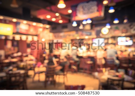 Blurred image sport and gumbo, oyster bar with TV, classic counter, tables and chairs in Houston, Texas, US. Bar Happy Hour, dine in abstract background. Night club, grill bar concept. Vintage filter.