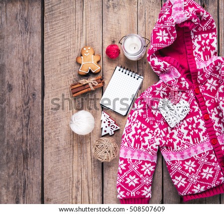 Christmas set. Warm blanket, sweater, candle, notebook, spices, cinnamon, pine cones, heart  on the wooden background