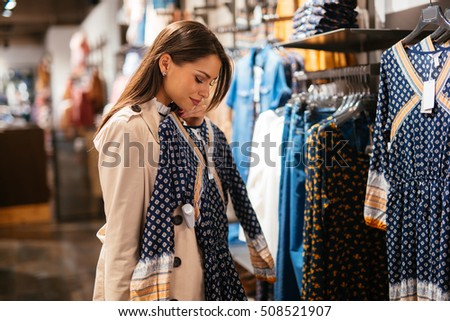 Beautiful businesswoman buying clothes