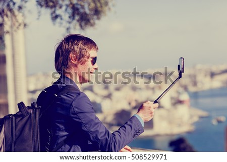young tourist taking a selfie photo while travel in Europe