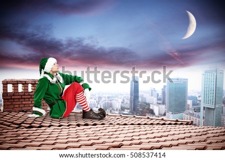 green elf and xmas time on roof 