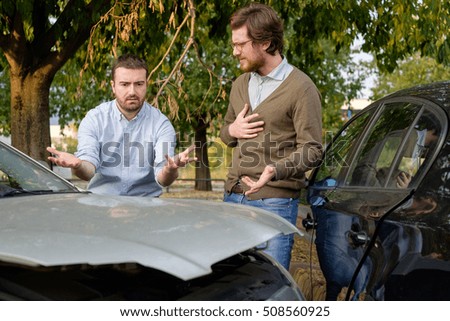 Two men arguing after a car accident on the road Royalty-Free Stock Photo #508560925
