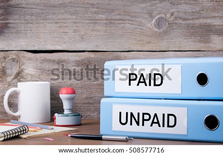 Paid and Unpaid. Two binders on desk in the office. Business background Royalty-Free Stock Photo #508577716