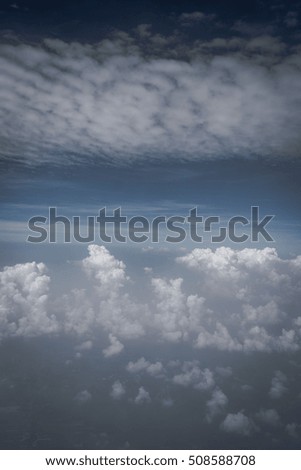 View of the sky before rain in high level. Looking through the window of the airplane