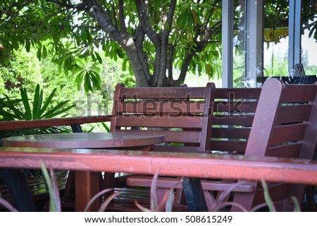 Coffee shop and group of chair table interior terrace in the building with brown outdoor nature in rainy season on a beautiful sunlight day.