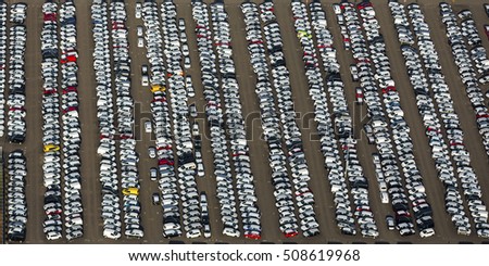 Aerial view of a huge parking place with more than hundreds of cars at a car dealership in The Netherlands