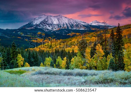 Fall rushes in to Colorado in the form of snow and frost at sunrise along Kebler Pass in Crested Butte as East Beckwith Mountain is covered in a fresh dusting. Royalty-Free Stock Photo #508623547