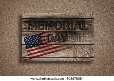the text "Memorial day" written in a rustic wooden background