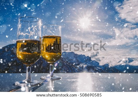 Beer glasses over Alps in snow