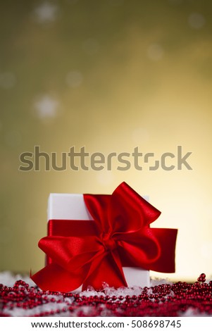 Beautiful gift box with red ribbon on Christmas background