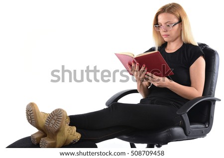 Young woman reading a book while sitting comfortably in an chair.Isolated on white background