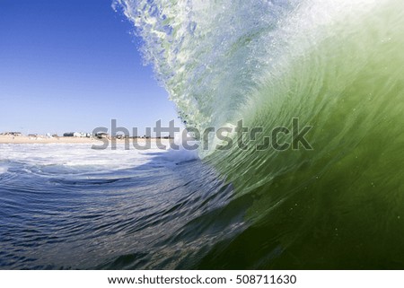 A wave breaking on a beach in the summer