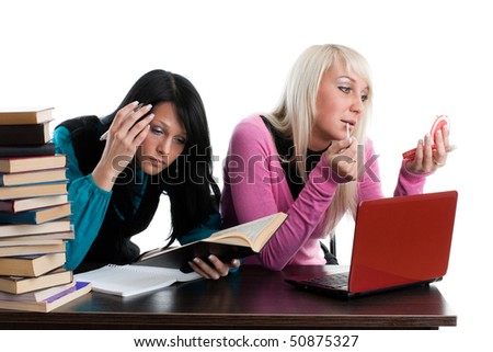 Two girlfriends of the student prepare for examination, sitting at a desk on a white background.