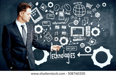 Businessman drawing creative technologies, information and social media sketch on chalkboard background