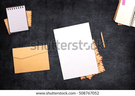 a letter with a notebook on the table