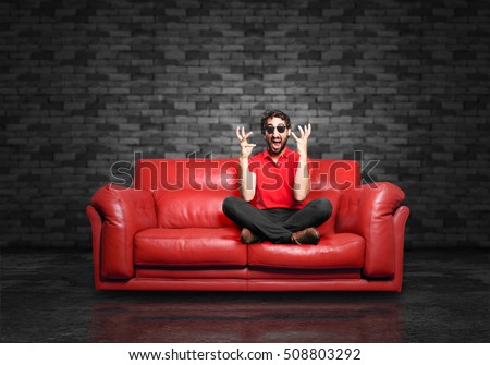 young funny man angry pose sitting down.