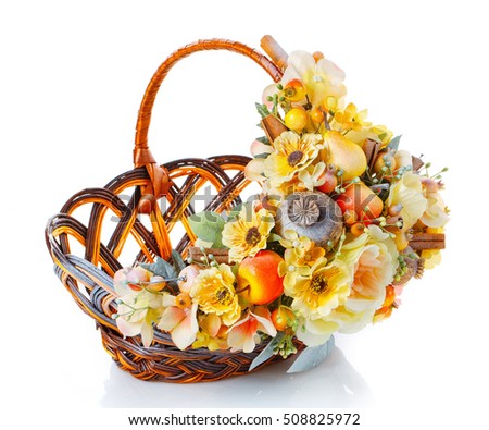 wicker basket decorated with flowers isolated on white