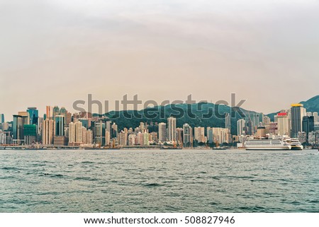 Cruise ship at Victoria Harbor of Hong Kong. View from Kowloon on HK Island.