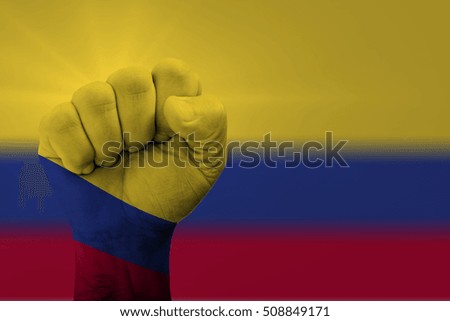 Man hand fist of COLOMBIA flag painted