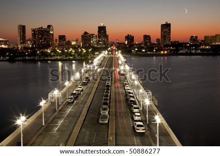 Beautiful sunset behind St. Petersburg, Florida skyline showing the city Pier in foreground