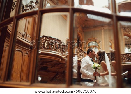 The lovely couple in love kissing on the stairs