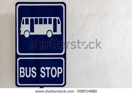 Blue bus stop sign on white wall background