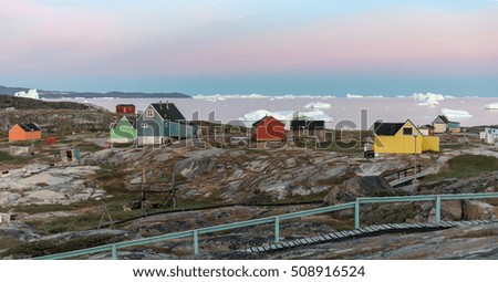 View of Disko Bay with icebergs from the village Oqaatsut summer night. The source of these icebergs is the Jakobshavn glacier, Greenland