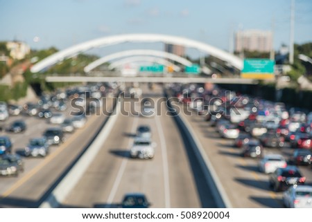 Blur image Interstate Highway 69 afternoon rush hour, downtown Houston, Texas, US. High-occupancy vehicle lane used at peak travel times.  Freeway trench with long-span arched bridge and street signs.