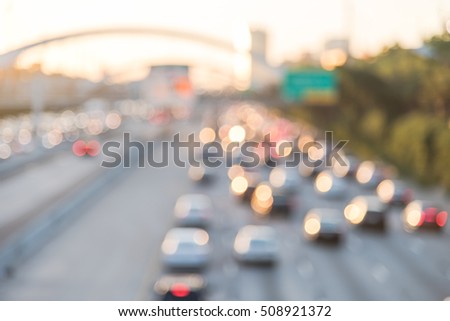 Blur image Interstate Highway 69 afternoon rush hour, downtown Houston, Texas, US. High-occupancy vehicle lane used at peak travel times.  Freeway trench with long-span arched bridge and street signs.