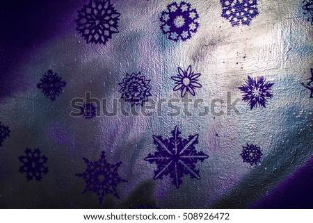 Wooden background with silver snowflake on blue and purple background. New Year, Christmas, background, texture.
