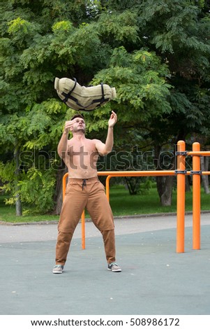 Man Performing Bag Squat Exercise Outdoor