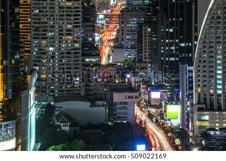 Highlight shadow of traffic and building density in bangkok at night.(With long exposure photography created movement of car light and blur trademark, brand, logo)