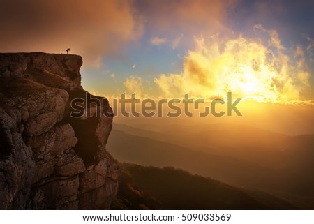 Beautiful mountain landscape with sunset sky in autumn time. Photographer takes pictures on top of the mountain 