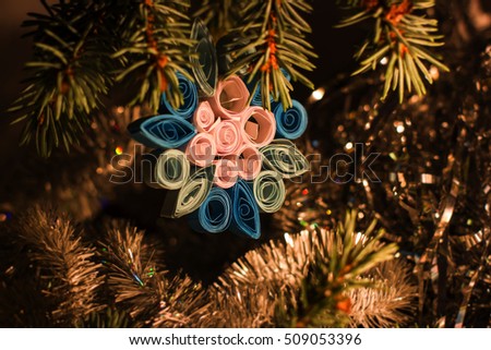 Christmas and New Year`s child craft. Hand made toy decorations on tree, fir cones and tree branches.  Greeting card Background concept with holiday tinsel.