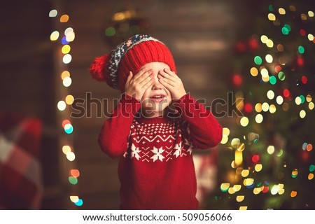 little girl closed eyes  her hands in anticipation of a Christmas miracle and a gift