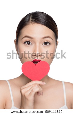 Cute attractive young woman with red heart. Valentine's day art portrait. Perfect make up