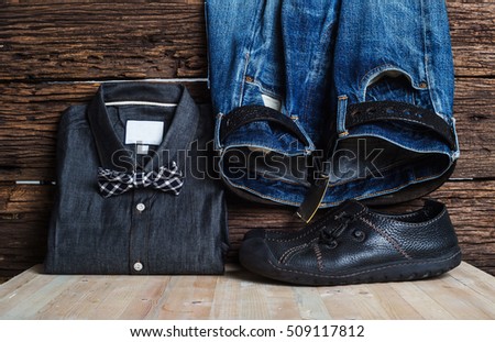 Shirt and blue jeans, and black leather shoes. on the old wooden floor. for design denim fashion. Retro style
