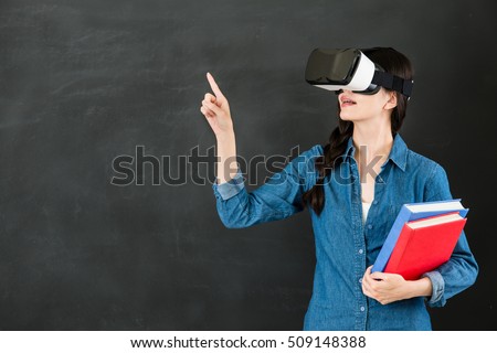 asian woman student touch screen with virtual reality. VR headset glasses device. blackboard background. school and education concept