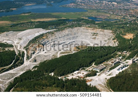 Limestone quarry on the background of urban areas, aerial photography.