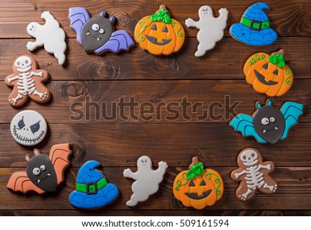Funny delicious ginger biscuits for Halloween on the old wooden table.