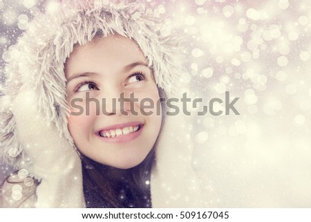 Beautiful girl on the winter background.
