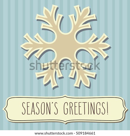 Beige snowflake and a frame with hand written season's greetings over vintage blue stripes background.