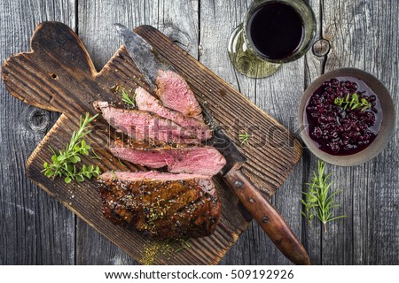 Vanison Steak on old Cutting Board Royalty-Free Stock Photo #509192926