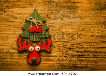Merry Christmas with green vintage christmas tree and a reindeer. wooden board with texture. 2017 happy new year
