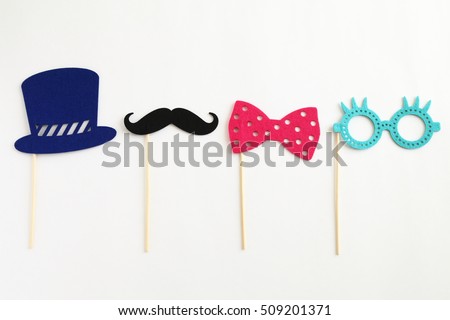 Photo booth colorful props for party - glasses, mustache, hat, ribbon on white background Royalty-Free Stock Photo #509201371