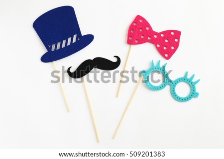 Photo booth colorful props for party - glasses, mustache, hat, ribbon on white background Royalty-Free Stock Photo #509201383