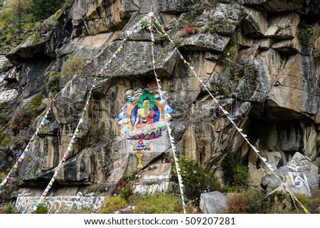 Buddha painting of Tibetan on stone in mountain zone in Sichuan, China