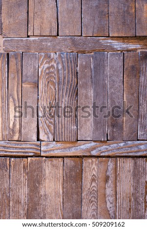 A picture of the old wooden parquet floor, old wood planks are poorly attached to each other, you can see the tree structure, the wood is dark and shabby, the edges of the planks are broken.